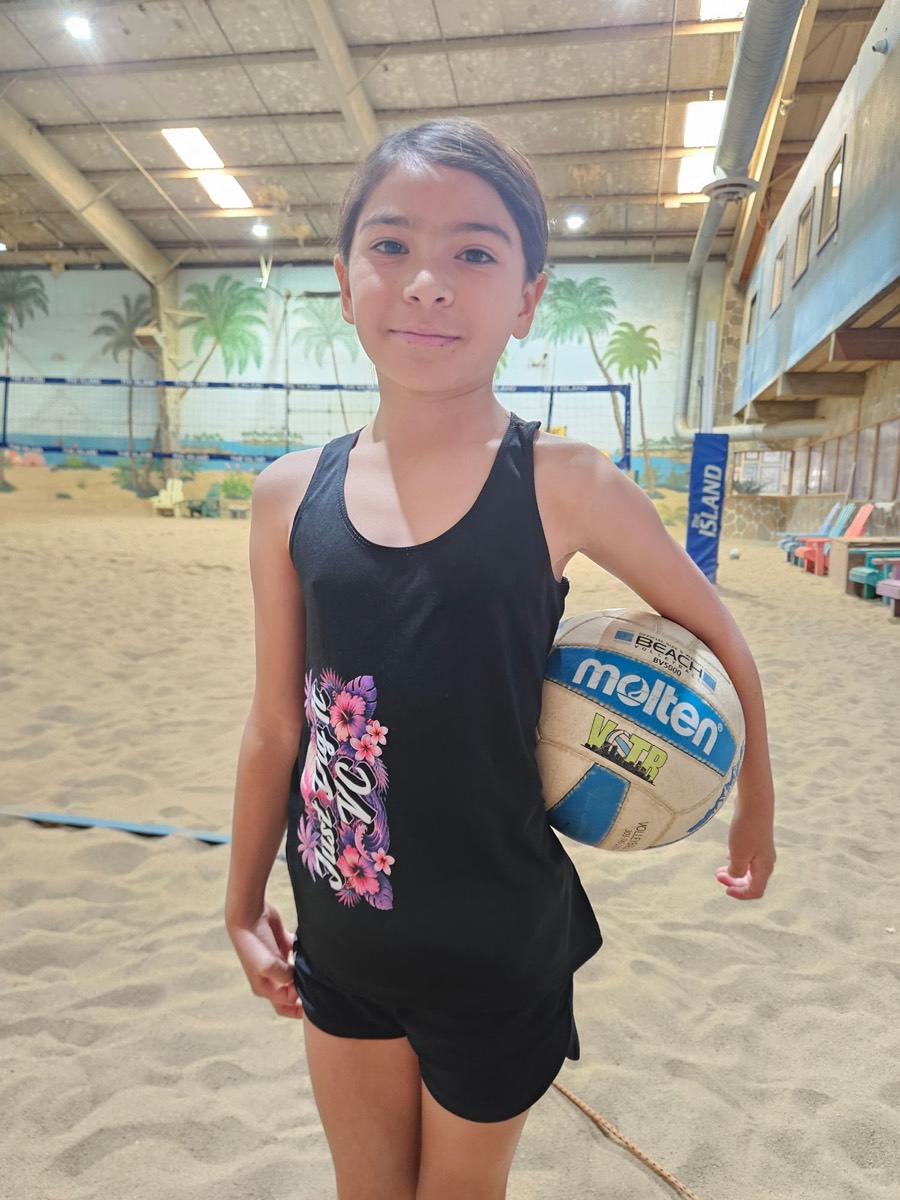 Just Dig It VC beach player holding a Molten beach volleyball