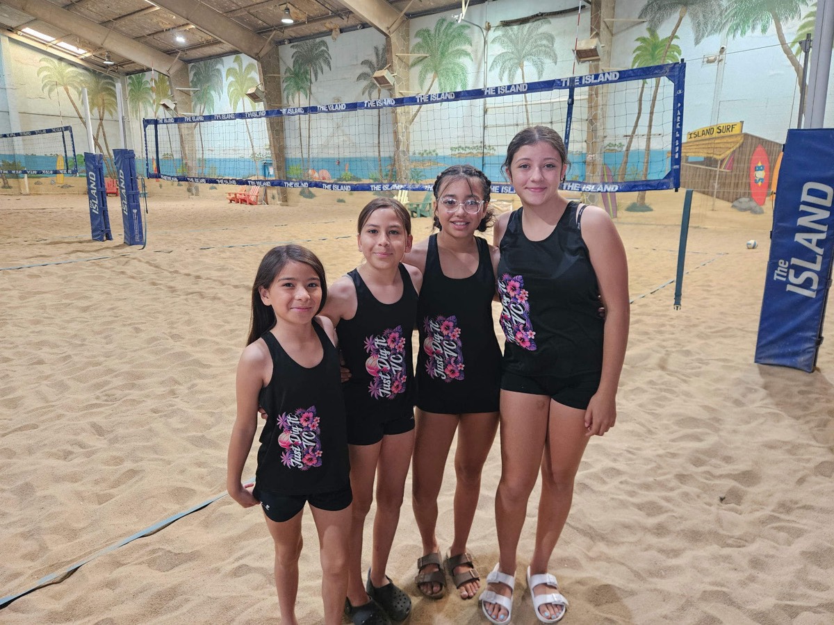 Four Just Dig It VC beach players on the indoor sand courts